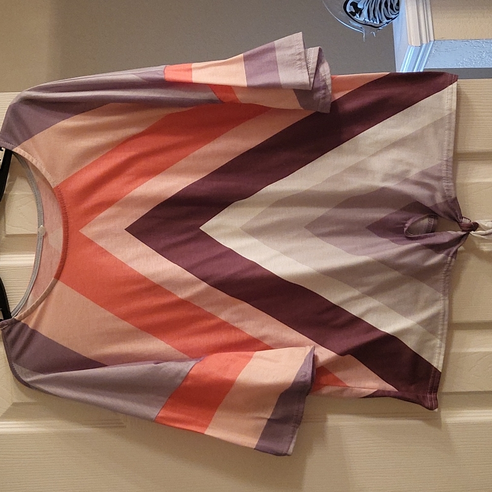 Womens colorful shirt of orange, brown, peach and white. Worn a few times